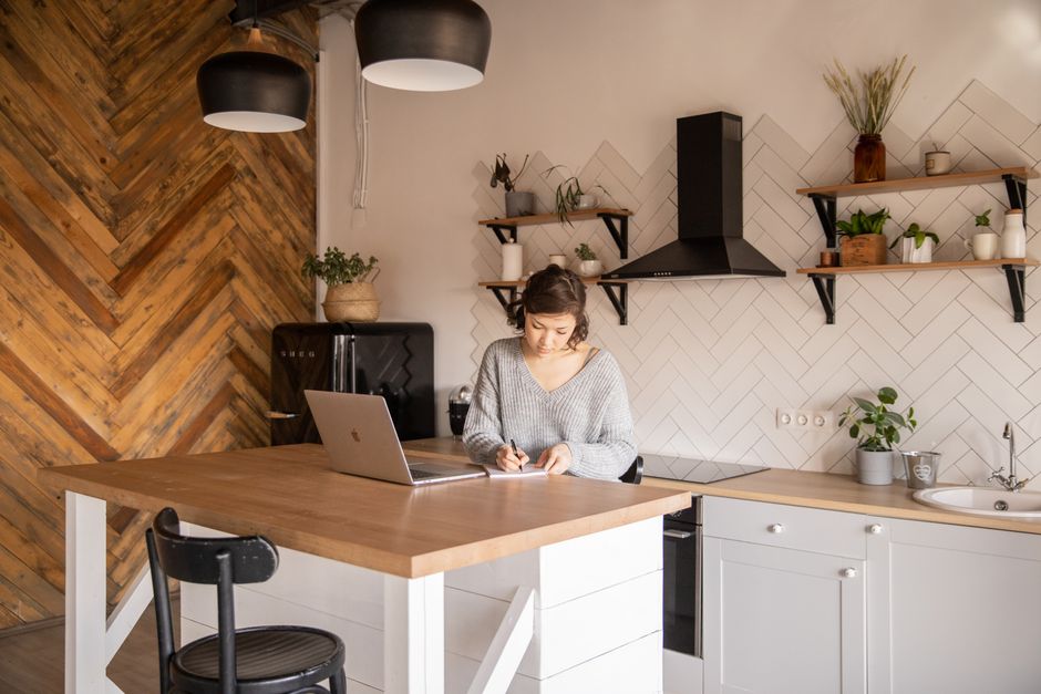 Kitchen designer working on plans in a showroom